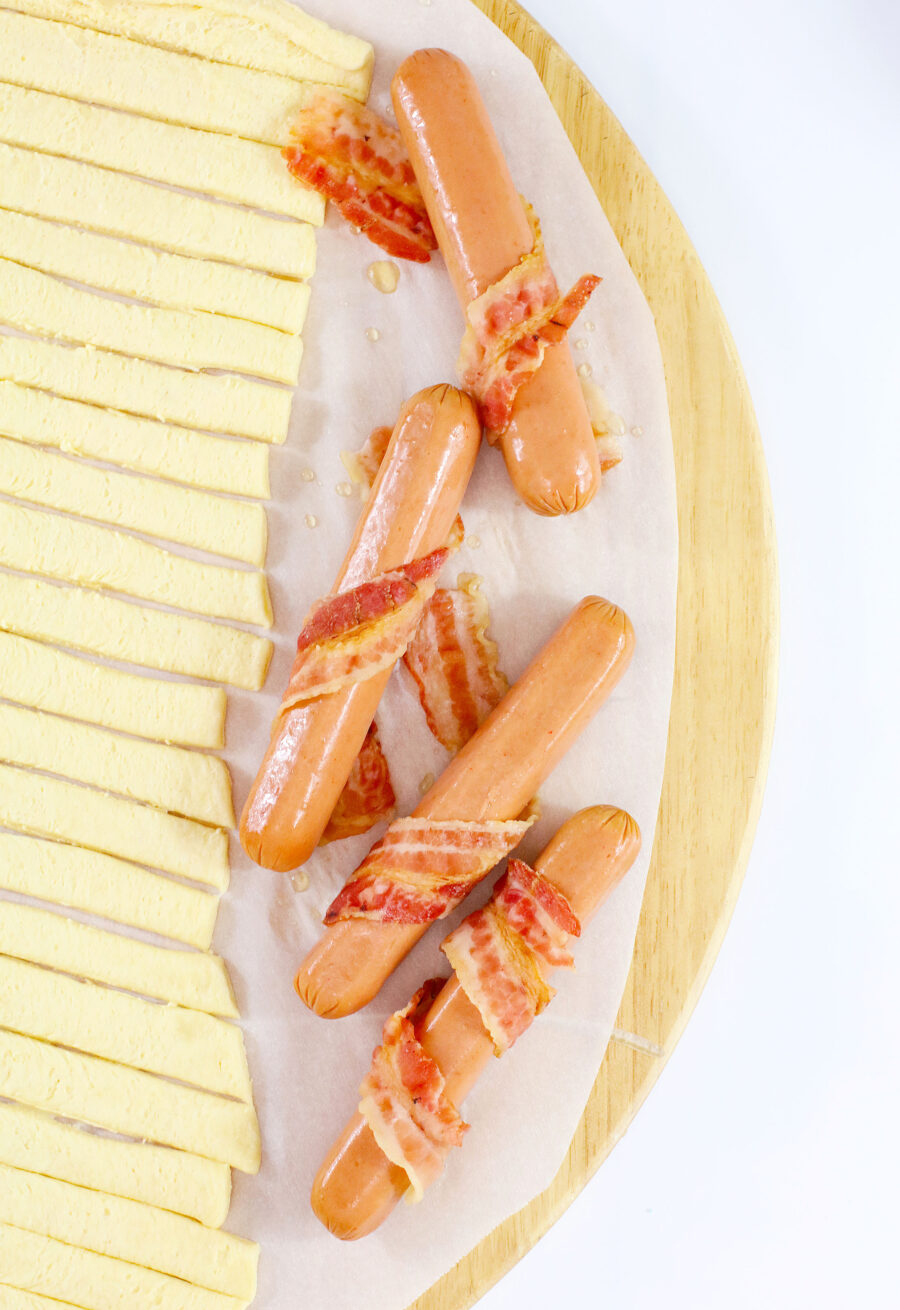 Bacon wrapped around hot dogs