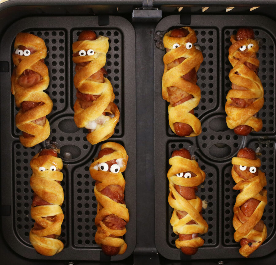 Cooked mummy dogs with candy eyes in air fryer