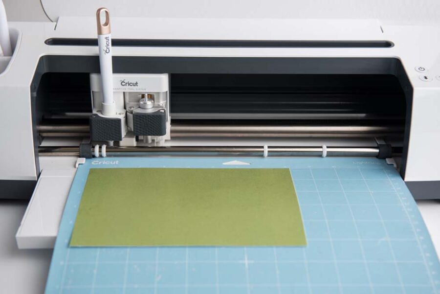 Green card stock on blue mat in a Cricut Maker