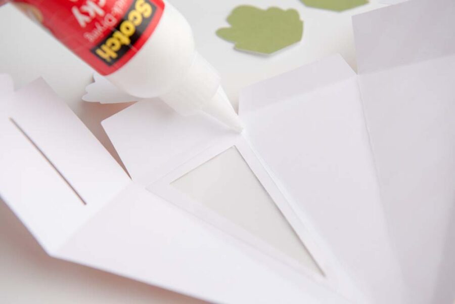 Acetate sheet being glued to inside of carrot box