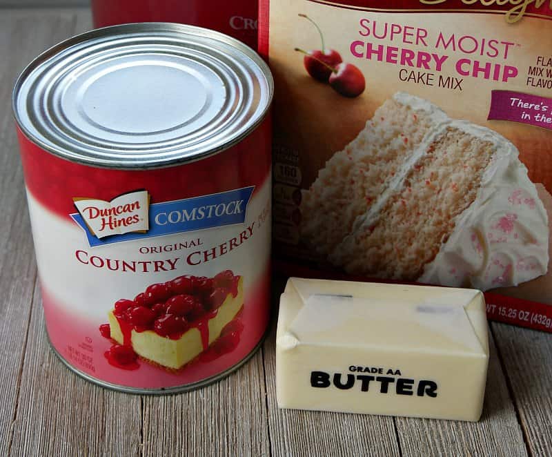 Can of cherry pie filling, a stick of butter and box of cherry chip cake mix