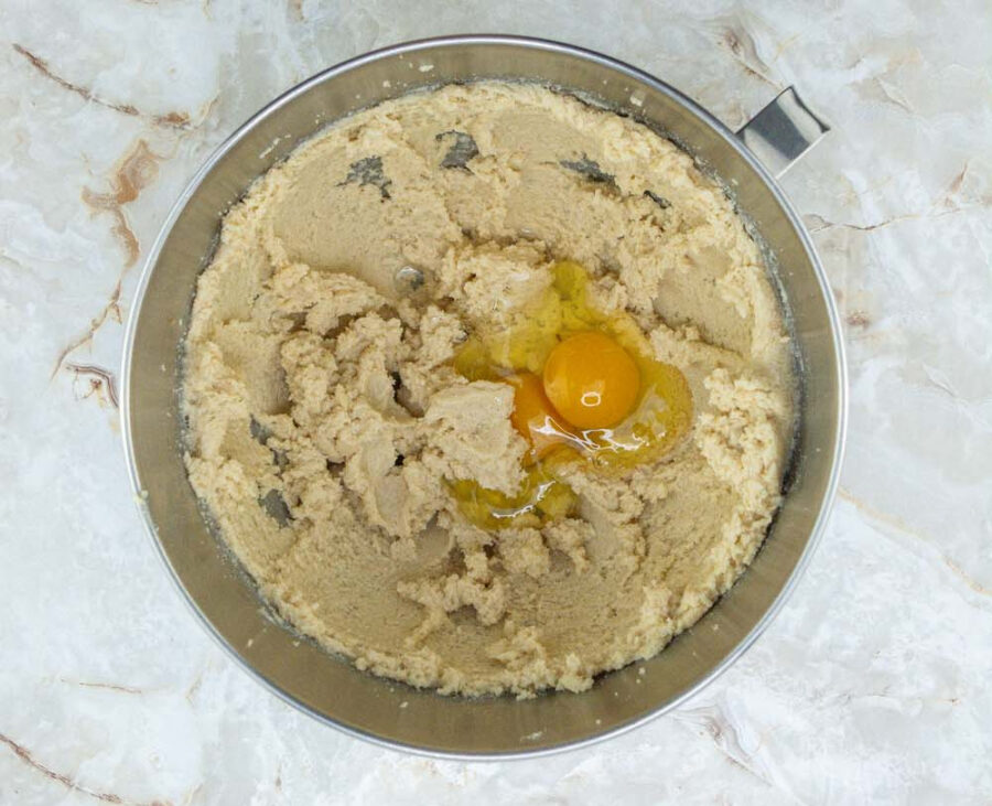 Eggs and sugars and butter creamed together in a mixing bowl