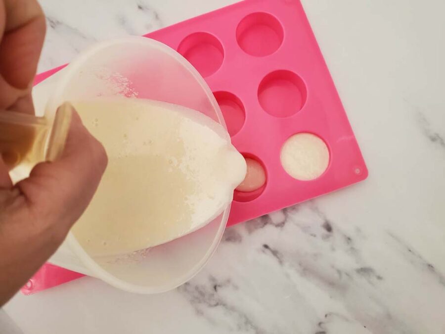 Pouring liquid sugar scrub bars into molds