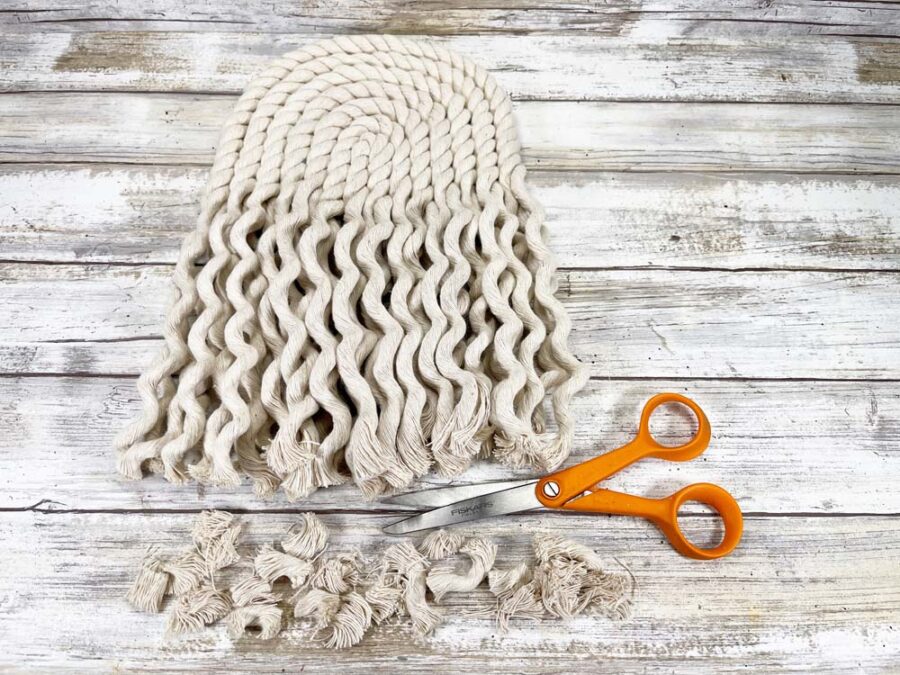 Trimmed ends of unraveled rope with a pair of scissors