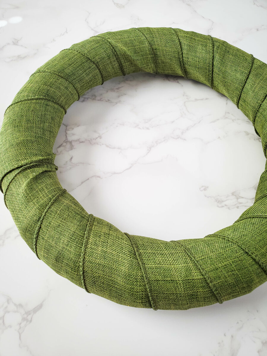 Green ribbon covering the wreath form
