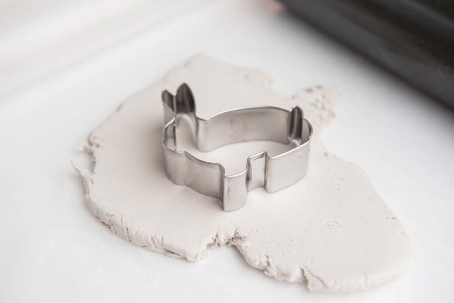 Bunny cookie cutter on top of white clay