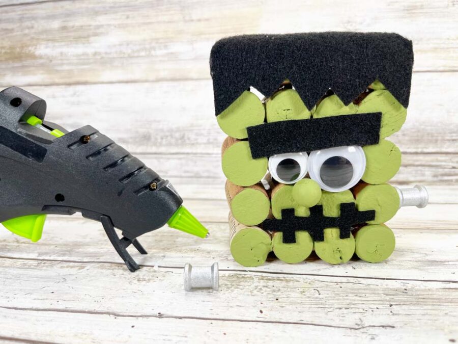 Glue gun, wooden spool and Frankenstein wine corks