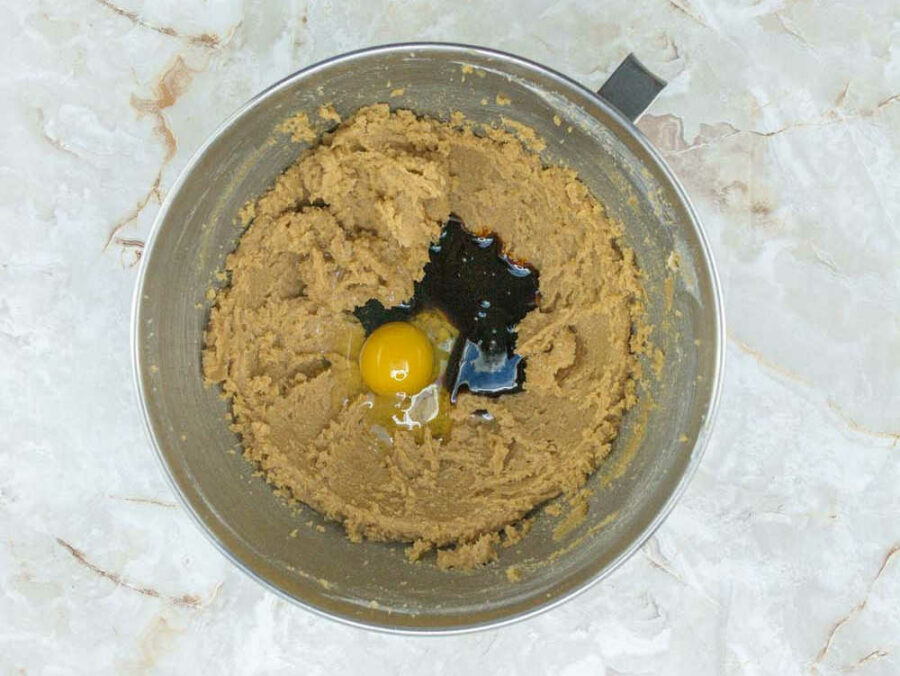 Eggs and molasses in a mixing bowl with creamed butter and sugar