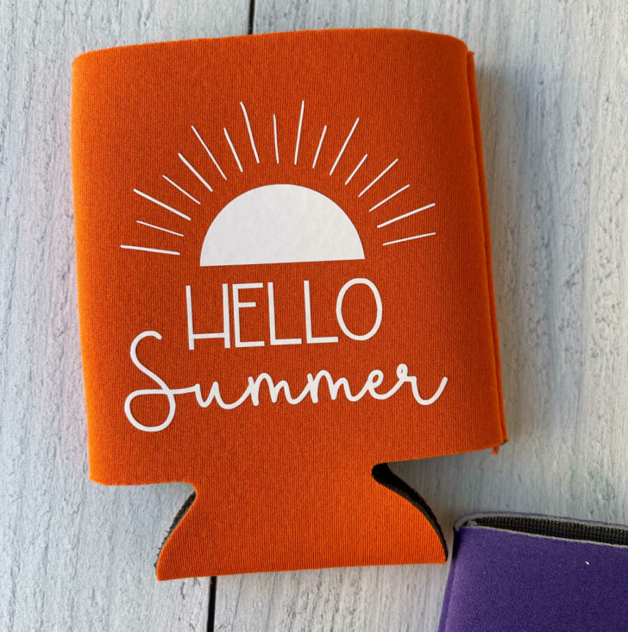 Orange Hello Summer Can Koozie on laying flat on a table