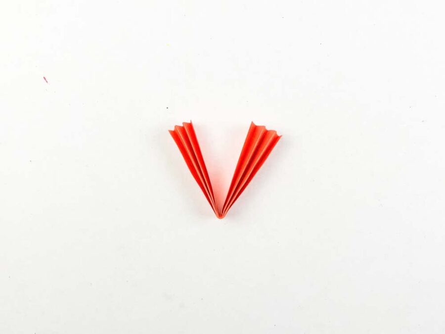 Orange paper accordion folded in half