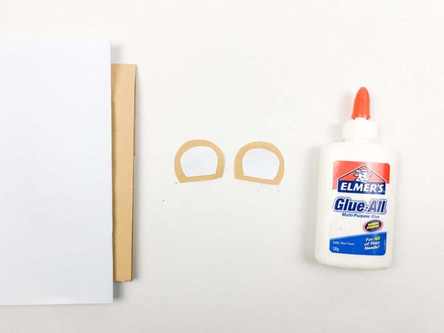 White half circle glued onto brown half circles made of paper