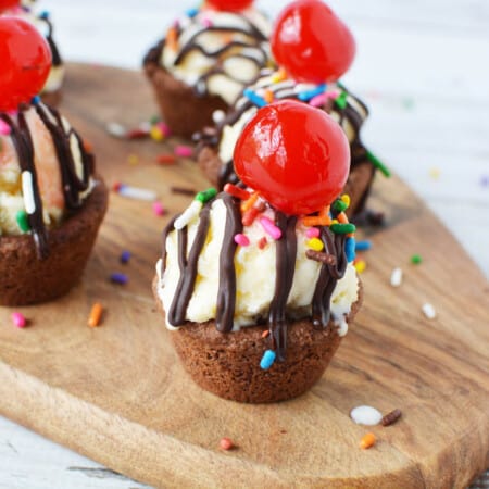 Chocolate peanut butter cookie cups with ice cream and cherry on top