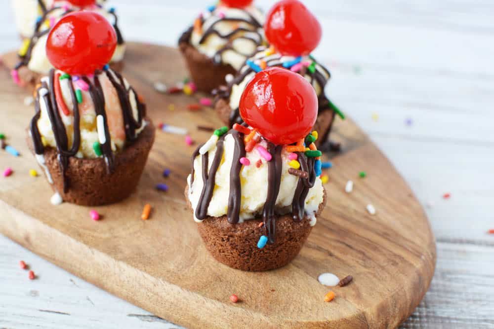 Chocolate peanut butter cookie cups with ice cream and cherry on top