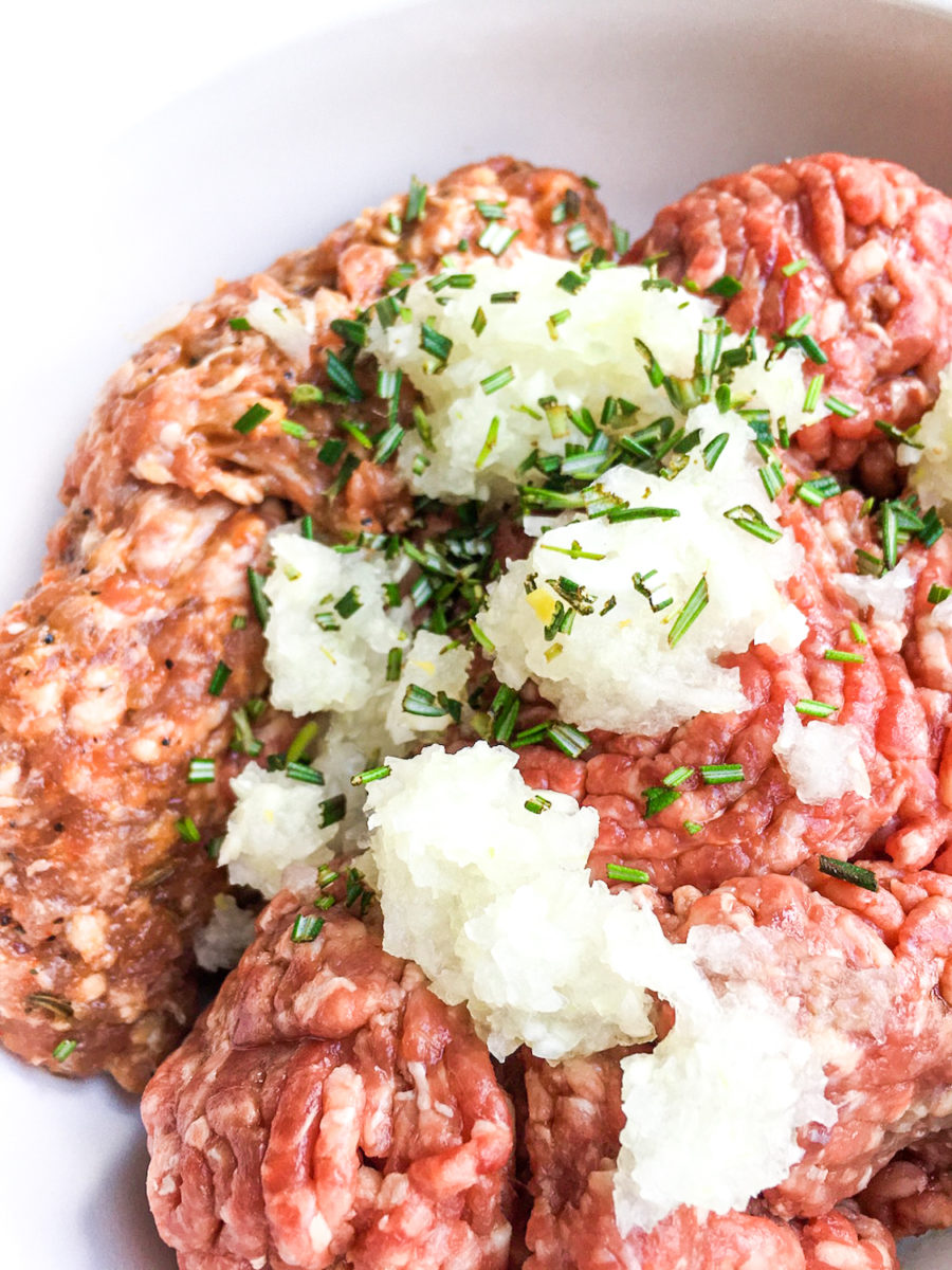 ground beef, sausage, Worcestershire sauce, onion, garlic, and rosemary in a large glass bowl