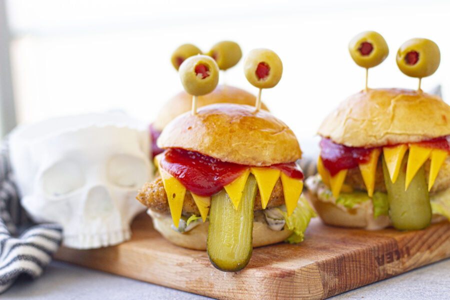3 monster burgers on a cutting board