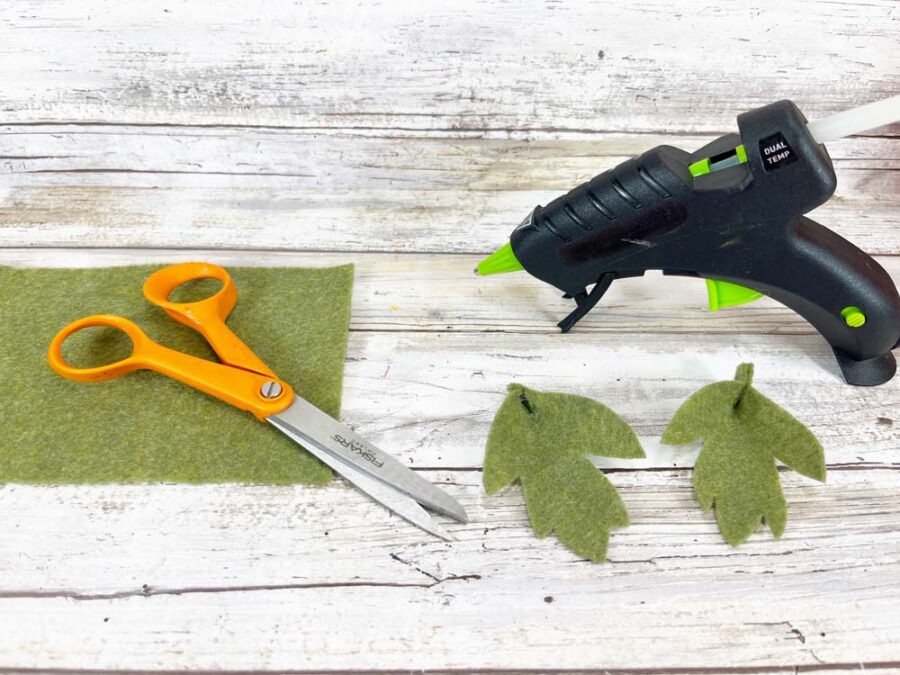 Green felt with scissors, felt leaves and hot glue gun