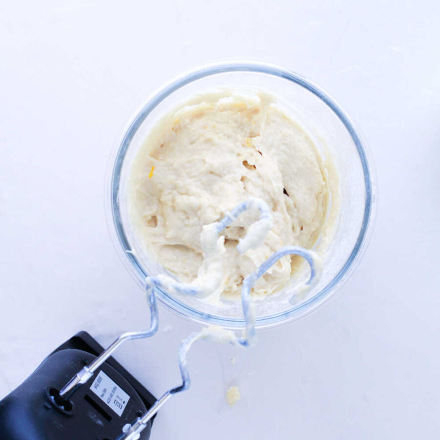 Orange roll dough with dough hook on mixer