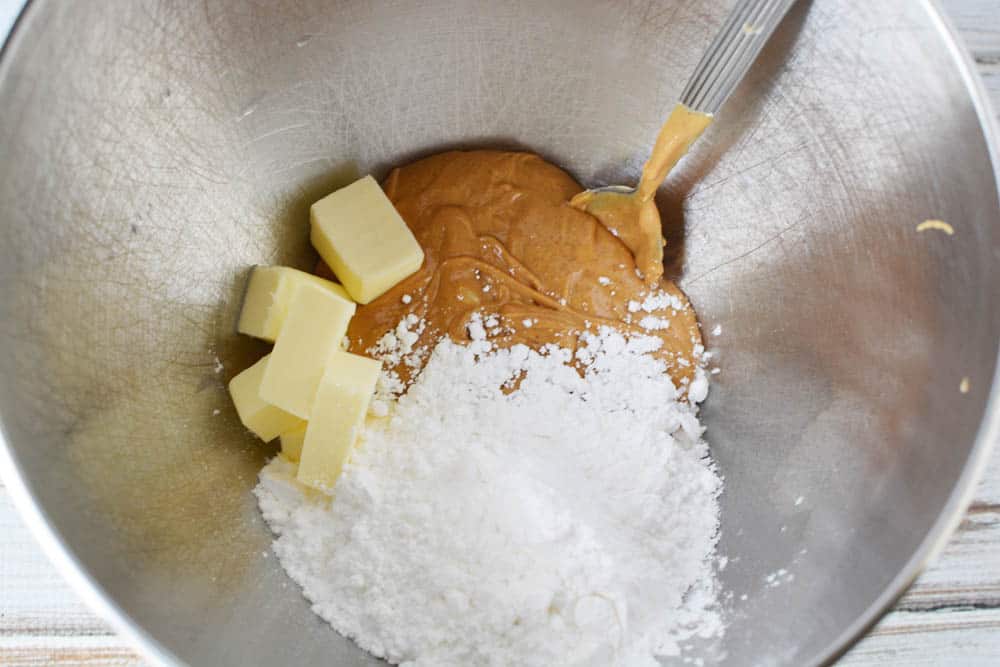 Peanut butter, butter and powdered sugar in a mixing bowl