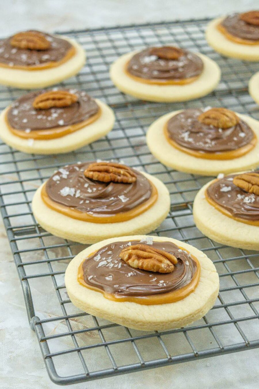 Finished pecan turtle cookies on cooling rack