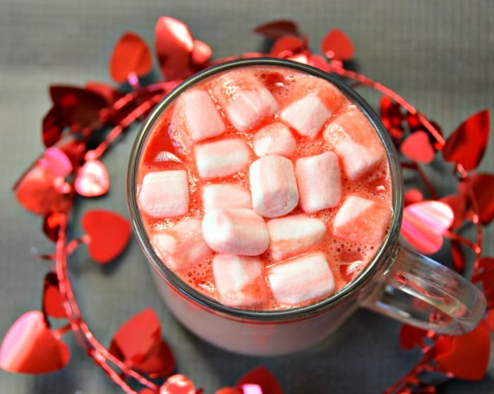 cup of pink hot chocolate with marshmallows taken from above 