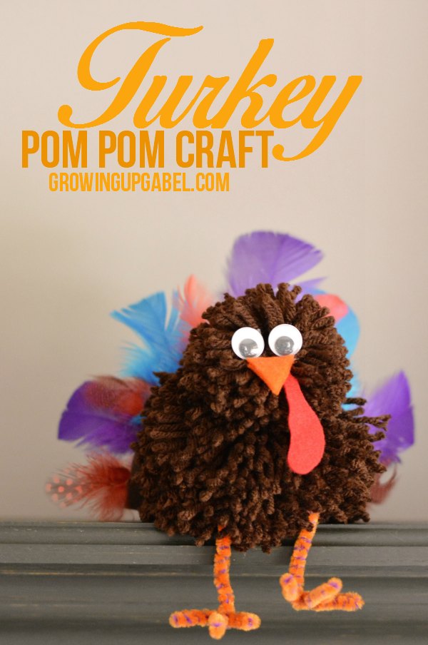 This adorable pom pom craft is the perfect kids Thanksgiving craft! Homemade pom poms are made in to a turkey and embellished with feathers, legs and a face! An adorable Thanksgiving craft!