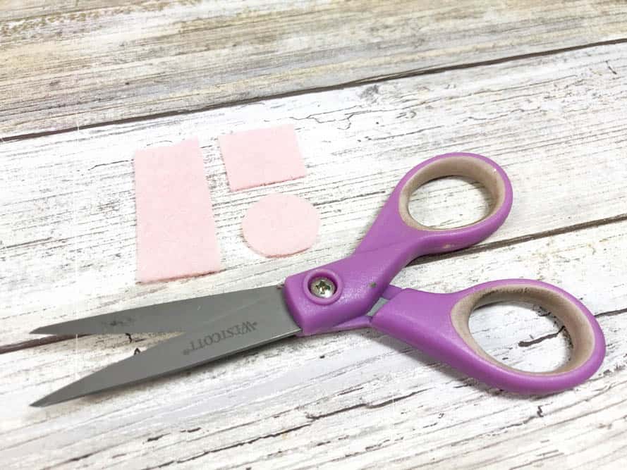 pink felt pieces for eyes and cheeks on felt rainbows