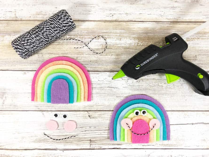 using twine to create smiles on Kawaii inspired felt rainbow craft for kids