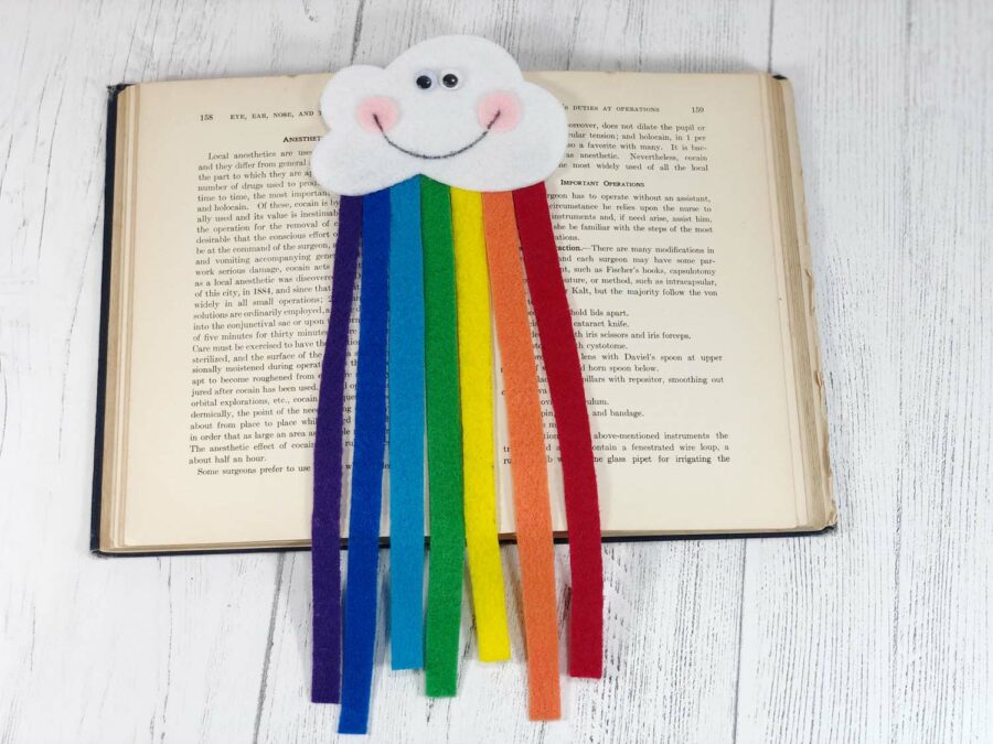 Rainbow bookmark laying on an open book