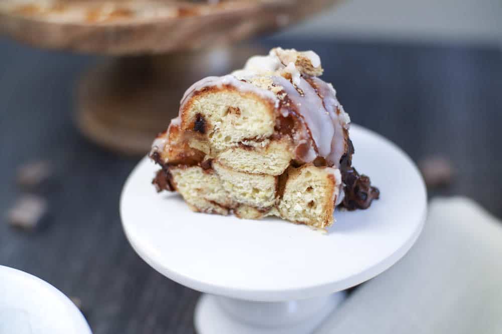 a slice of s'mores monkey bread on a small white cake plate