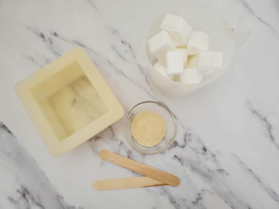 Soap mold, powdered honey, cut up soap base, and craft sticks.