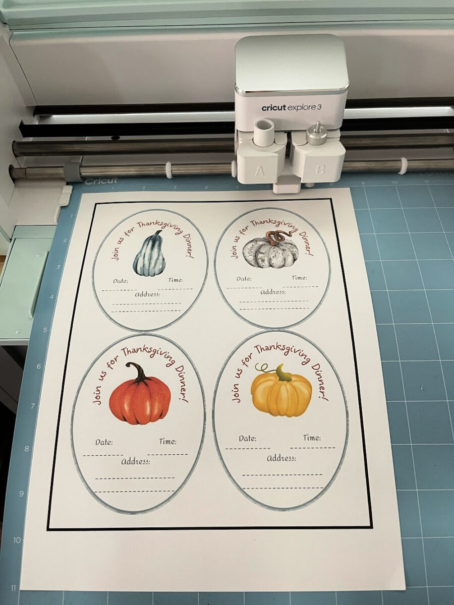 Thanksgiving dinner invitations on a Cricut cutting mat.