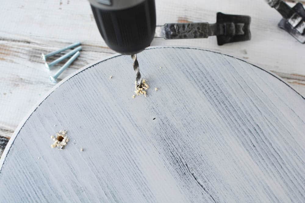 holes being drilled into a wood tray with a drill bit