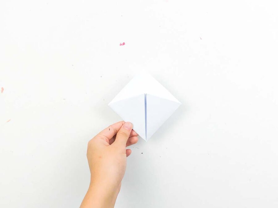 A hand holding the finished bookmark