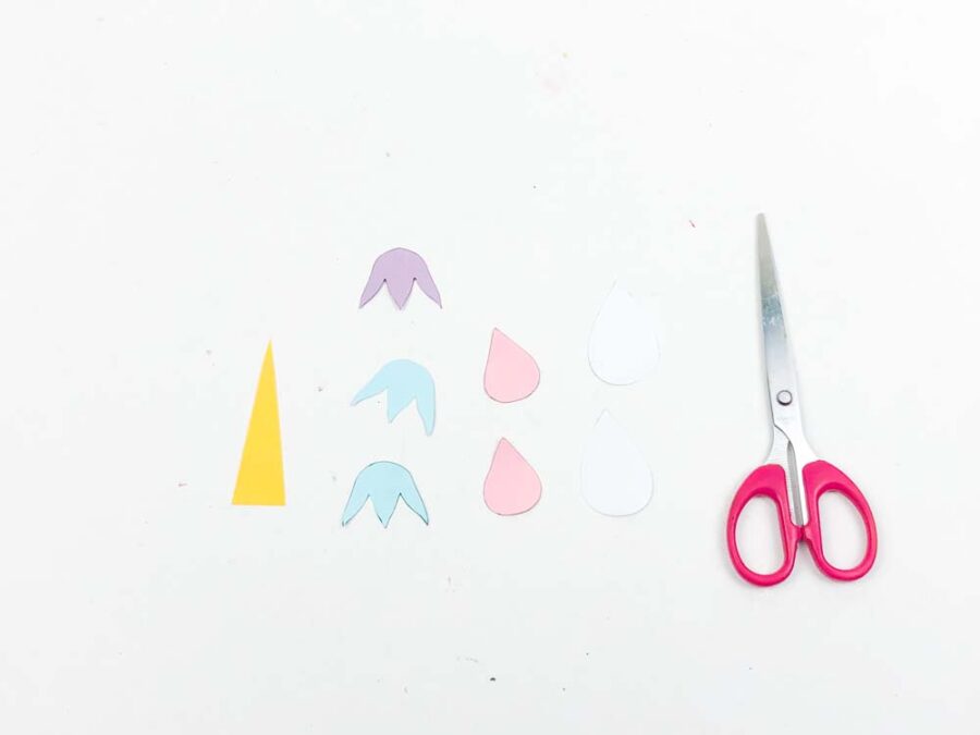 Unicorn template piece cut out next to a pair of scissors