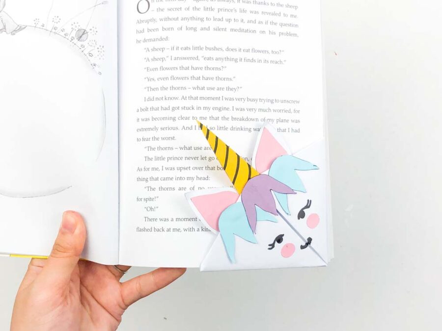 Unicorn bookmark in the corner of a book