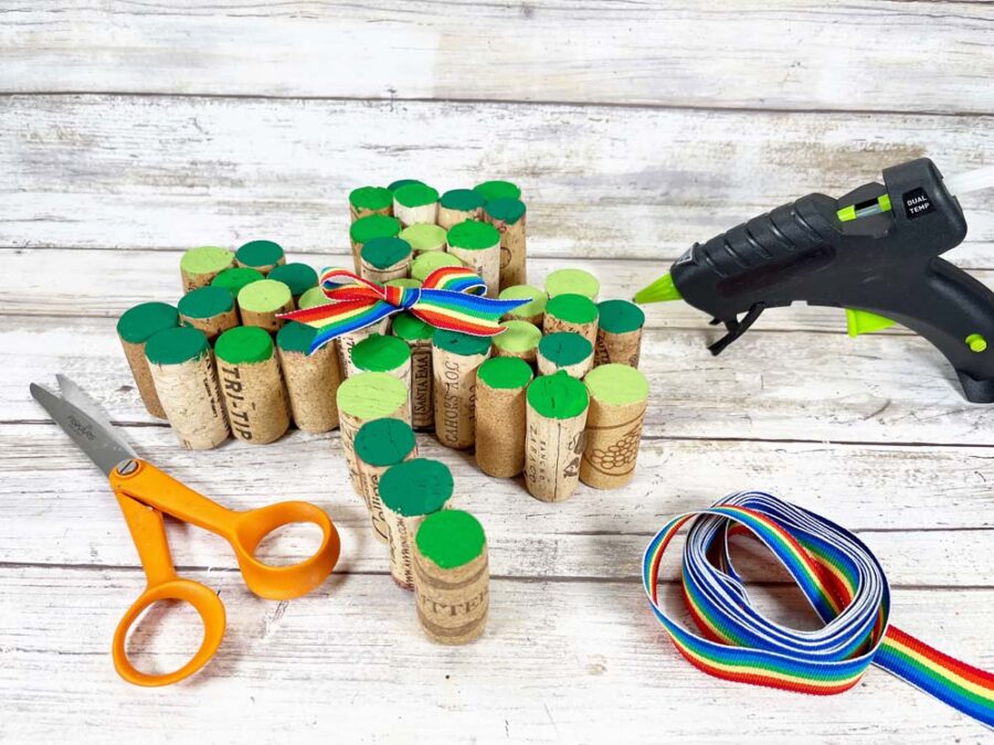 Gluing a ribbon to the center of the wine cork shamrock