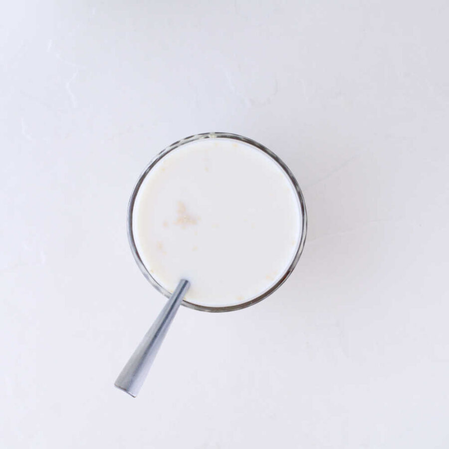 Milk and yeast with spoon in bowl