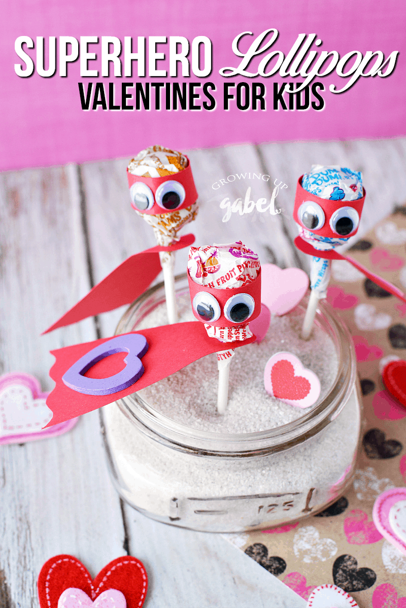 Lollipop superhero valentines day cards are made out of Dum Dum lollipops, construction paper, and googly eyes! Perfect for Valentines Day parties for kids!
